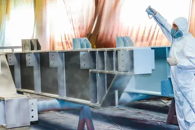 Industrial powder coating process inside coating facility in Melbourne